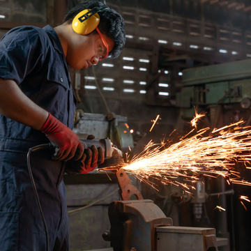 Man soldering at a manufacturing plant